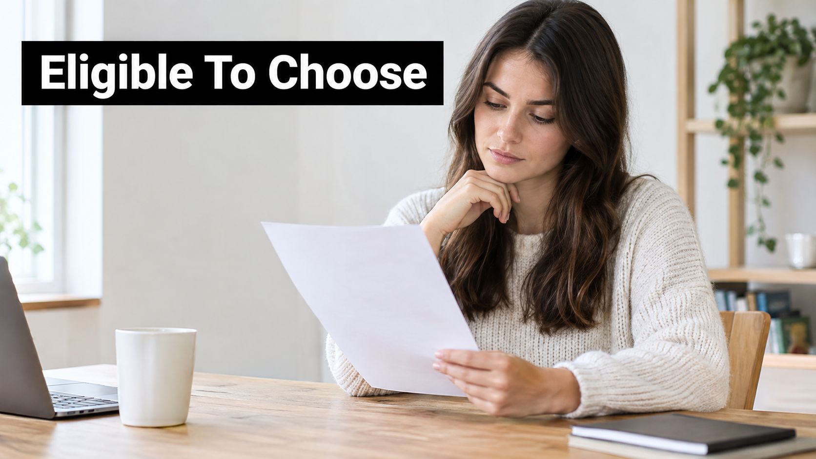 A young woman sits at a wooden desk reading a document with a thoughtful expression.